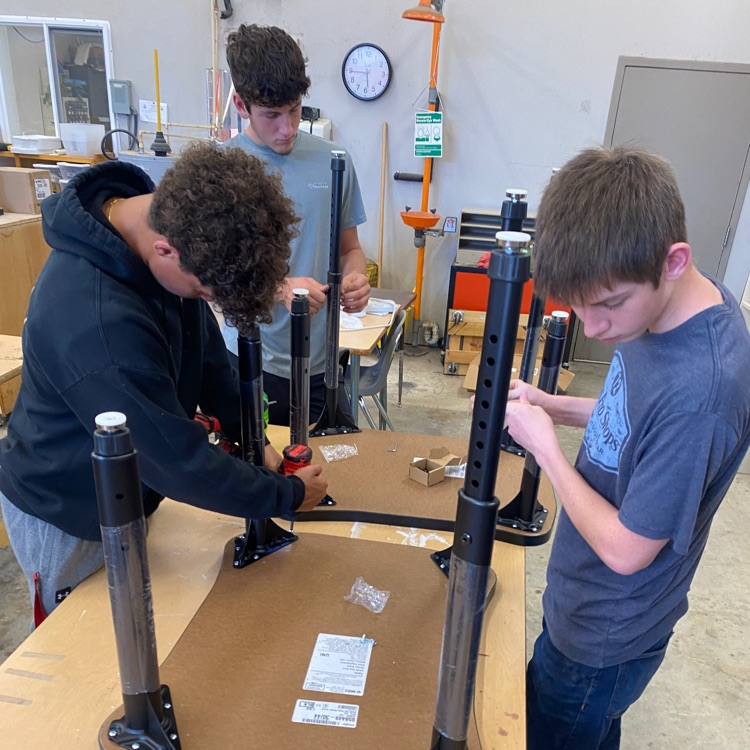 students putting together furniture/equipment 