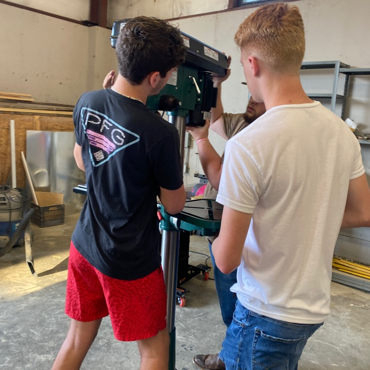 students putting together furniture/equipment 