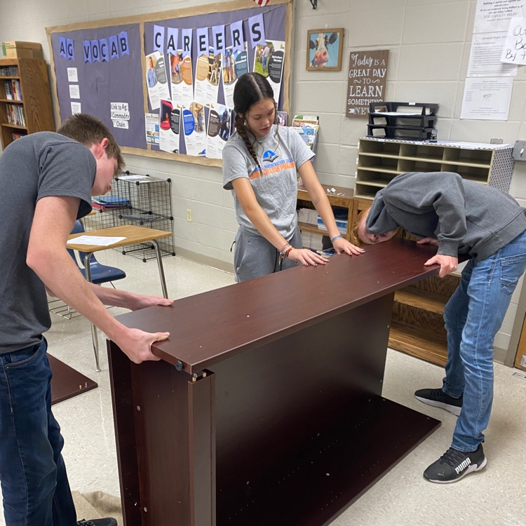 students putting together furniture/equipment 